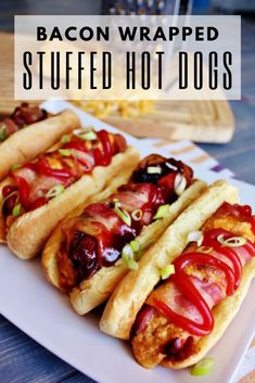 bacon wrapped stuffed hot dogs on a white plate