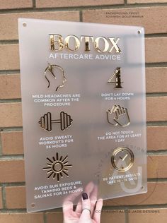 a person holding up a metal sign with different symbols on it's face and the words botox aftercare advice