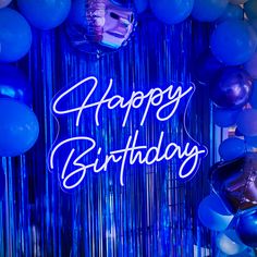 blue balloons and streamers with the words happy birthday