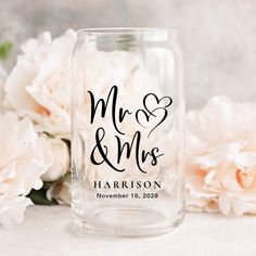 personalized mason jar with mr and mrs written on the front, surrounded by peonies