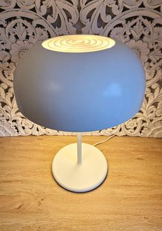 a blue lamp sitting on top of a wooden table