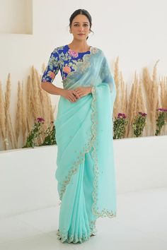 Aqua blue scallop trimmed saree with hand embroidery detailing. Paired with a royal blue padded silk blouse with fiza print, and detailed with hand embroidery. - Aza Fashions Traditional Blue Pre-draped Saree With Floral Embroidery, Blue Silk Pre-draped Saree With Floral Embroidery, Blue Georgette Blouse Piece With Floral Embroidery, Blue Georgette Saree With Floral Embroidery, Blue Saree With Floral Embroidery For Reception, Blue Floral Embroidered Saree For Reception, Semi-stitched Blue Pre-draped Saree With Floral Embroidery, Blue Partially Stitched Pre-draped Saree With Floral Embroidery, Designer Blue Saree With Floral Embroidery