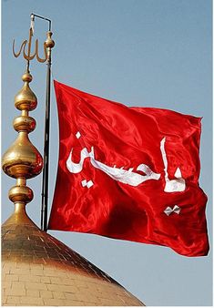 a red flag flying on top of a building next to a golden dome with a chandelier