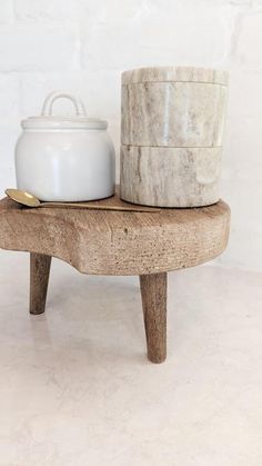 a white pot sitting on top of a wooden table