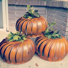 three pumpkin shaped planters sitting on the ground