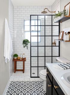 a bathroom with black and white tiles on the floor