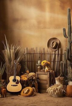 an arrangement of cactus, sunflowers and other plants in a room with a guitar on the floor