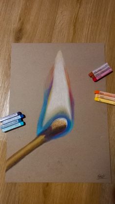 colored pencils and an artist's brush on a piece of paper