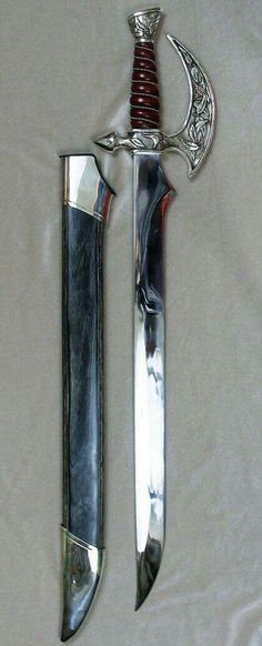 two knives are laying next to each other on a white sheet with a knife in the middle