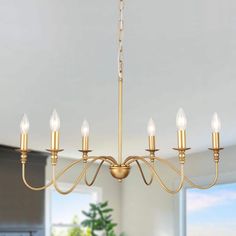 a chandelier with six lights hanging from the ceiling in a living room or dining room