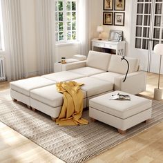 a living room with a large white sectional couch