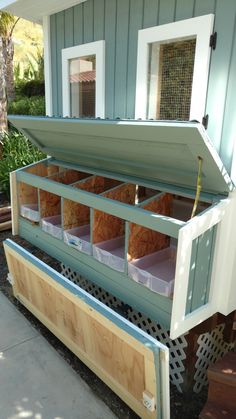 an open storage box on the side of a house that has been built into it