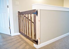 an empty room with a baby crib in the corner and a door on the far wall