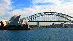 the sydney opera house and harbour bridge as seen from across the water