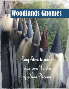 several gnomes are lined up on a fence with the words woodland gnomes written below them