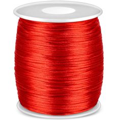 red thread spooling on a white background