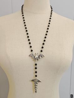 Complete your gothic look with our black gothic bat necklace with beads! This stunning necklace features a bat design adorned with intricate beads, adding a touch of mystery and elegance to any outfit.   Please note that this product includes only the necklace. Adjustable Vampire Necklace For Halloween, Gothic Black Beads Jewelry For Halloween, Gothic Black Beads Halloween Jewelry, Adjustable Black Vampire Style Necklaces, Adjustable Black Vampire Necklace, Black Necklace For Halloween Cosplay, Vampire Style Black Necklace For Halloween, Gothic Beaded Jewelry For Halloween, Gothic Beaded Halloween Jewelry