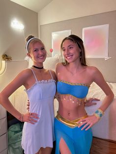 two young women dressed up in costumes posing for the camera, one wearing a belly ring