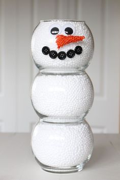 a snowman made out of balls sitting on top of a table