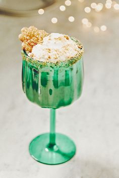 a green cocktail with whipped cream and sprinkles