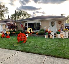 halloween yard decorations in front of a house