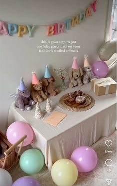 a birthday party with balloons and stuffed animals