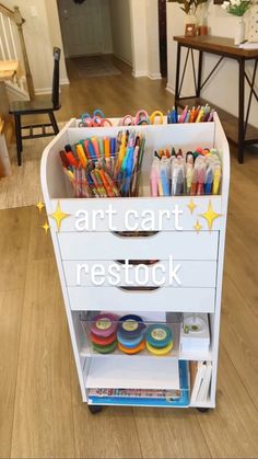 the cart is filled with lots of different colored pens and pencils in it's drawers