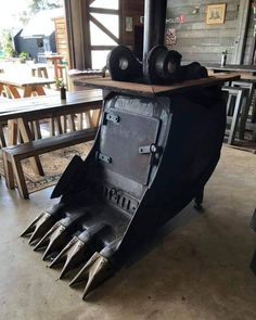 a large metal object sitting on top of a wooden table next to a fire place