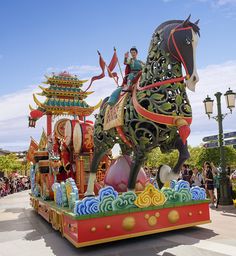 an elaborately decorated horse float in a parade