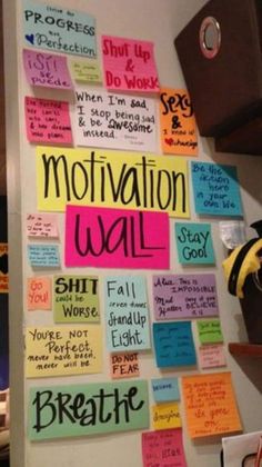 a bulletin board with motivational notes on it in an office cubicle that says motivational wall