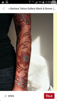 a woman with tattoos on her arm and arms is seen in this screenshote