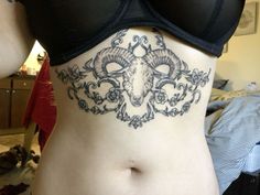 a woman with a tattoo on her stomach