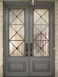 two double doors with glass on each side and the other side is open to reveal an entry door