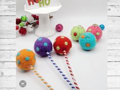 several colorful balls and candy sticks on a white table with a happy hoo sign in the background