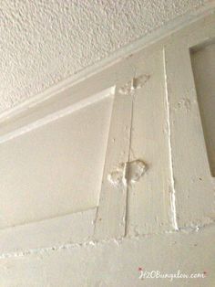 the corner of a door with paint chipping on it's side and an opening in the wall