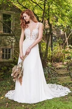 a woman in a wedding dress holding a bouquet