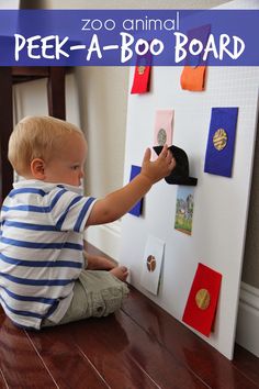 a young boy sitting on the floor playing with a toy boat and magnets in front of him