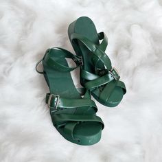 Step Into Style With These Rare Vintage Flexiclogs Women's Sandals In A Beautiful Shade Of Green. These Sandals Feature An Articulated Design With A Wood Sole And Strap, Perfect For Any Casual Occasion. The Unique Style And Material Make These Sandals A Must-Have For Any Vintage Shoe Collector. These Sandals Are Perfect For Those Who Love The Art Of Nature. The Green Color Adds A Touch Of Freshness To Any Outfit. Ideal For Those Who Love Sandals And Flip Flops, These Flexiclogs Sandals Are A Gre Green Wedge Sandals With Heel Strap And Round Toe, Green Open Heel Sandals With Rubber Sole, Green Ankle Strap Heels With Wooden Heel, Green Sandals With Wooden Open Heel, Green Closed Toe Sandals With Heel Loop, Green High Heel Sandals With Wooden Heel, Green Sandals With Wooden High Heel, Green Closed Toe Sandals With Wooden Heel, Green Closed Toe Clogs With Buckle Closure