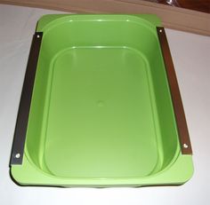 an empty green tray on a white table