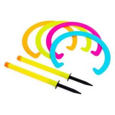 a set of four neon colored scissors next to each other