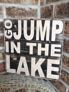 there is a sign that says jump in the lake and it's written on it