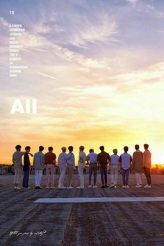 a group of men standing on top of an airport tarmac with the sun setting in the background