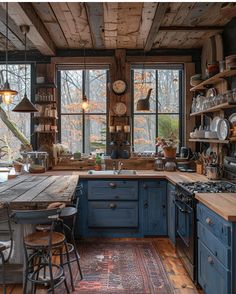 a rustic kitchen with blue cabinets and wooden floors, an old - fashioned rug on the floor