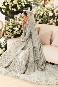 a woman in a wedding dress sitting on a couch