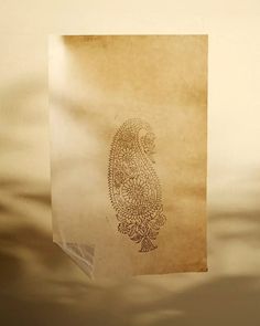 a piece of paper with an image of a bird on it hanging from the wall