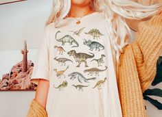 This Dinosaur Tshirt is a perfect dinosaur gift for dinosaur lovers likes tyrannosaurus rex T-Rex, Stegosaurus,Parasaurolophus and velociraptor. Perfect to wear at fossil hunting, museums trips or a dinosaur theme birthday parties. Also available on: .. Browse through my other awesome items here: http://thenims.etsy.com/ UNISEX TEES Bella Canvas 3001™ (CUSTOMER FAVORITE) This updated unisex essential fits like a well-loved favorite. Super soft cotton and excellent quality print makes one to fall Womens Dinosaur Shirt, Dinosaur Shirt Aesthetic, Dinosaur Party Outfit Women, Mom Dinosaur Shirt, Dinosaur Shirt Women, Dinosaur Outfit Women, Dinosaur Outfit Aesthetic, Dinosaur Clothes Women, Dinosaur T Shirt