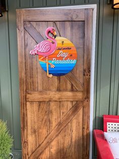 a wooden door with a flamingo sign on it