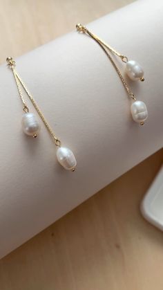 Behind the scene on how I assemble these beautiful pearl earrings with double gold strands Elegant Bridal Earrings With Pearl Chain, Delicate Dangle Linear Earrings With Adjustable Chain, Gold-plated Delicate Chain Earrings, Delicate Gold-plated Chain Earrings, Delicate Gold Plated Chain Earrings, Elegant Linear Earrings With Pearl Chain As Gift, Elegant Pearl Chain Linear Earrings Gift, Elegant Pearl Charm Earrings In 14k Gold Filled, Chic Dangle Threader Earrings Gift