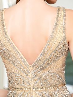 the back of a woman's dress with beading on it