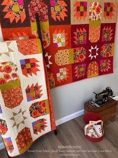 two quilts hanging on the wall next to each other